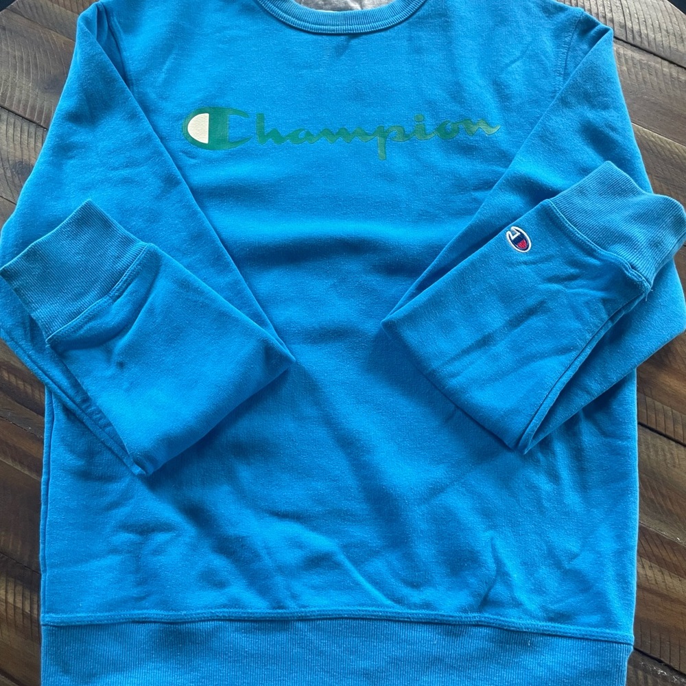 Blue Champion sweatshirt with green logo on front. Like new condition.